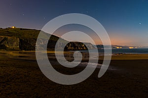 Night view of Zumaia beach with low tide and full moon light