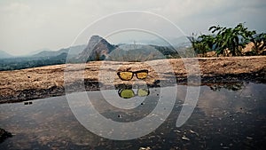 Night vision glasses with the water reflection covered by the natural background view