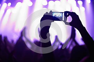 Nightclub, concert and audience with phone or lights for music, party and rave festival with silhouette and dancing