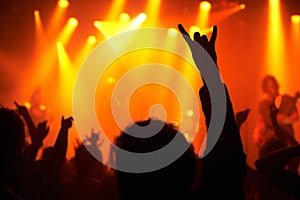 Nightclub, concert and audience with rock or sign for music, band and rave festival with silhouette, dancing or show