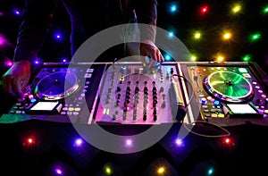 Nightclub DJ mixing decks at a house party, disco, rave or wedding