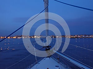At nightfall, the sailboat arrives at the port photo