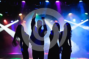 Nightlife and disco concept. Young people are dancing in club.