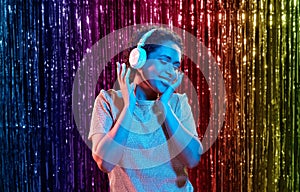 woman in headphones listening to music at party photo