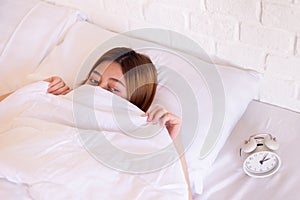 Nightmare or bad dream,Asian woman with fear and panic while lying down under the blanket in bedroom