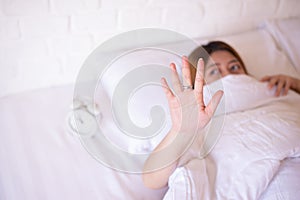 Nightmare or bad dream,Asian woman with fear and panic while lying down under the blanket in bedroom