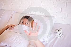 Nightmare or bad dream,Asian woman with fear and panic while lying down under the blanket in bedroom