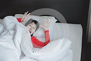 Nightmare or bad dream,Woman with scare and panic while lying down under the blanket in bedroom