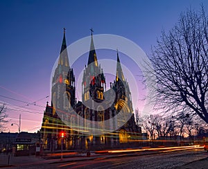 Nightscape of ancient gothic church with autotracks
