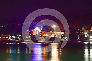 Nightscape of Hindu temple and ghats on Ganga river at Rishikesh.