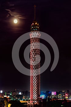 Nightscape shot for the moon over Cairo Tower with egyptian flag colors lights in Egypt