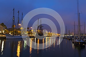 Nightscene with tall ships in harbour