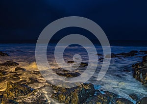Nightshot of the waves and rocks at the indian ocean at the Wild Coast photo