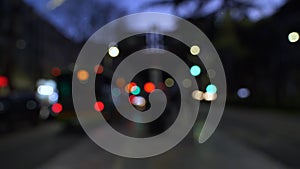 A nighttime blur of buses and cars at an urban bus stop