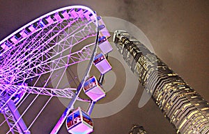 Nighttime Ferris Wheel and Skyscraper in Hong Kong