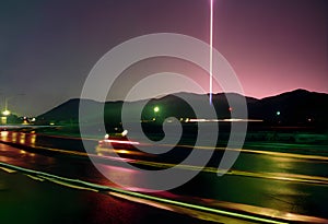 Nighttime Highway Beneath Cosmic Beacon, A Long Exposure of Movement and Mystery