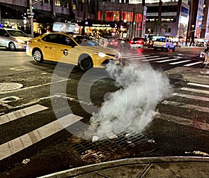 Nighttime image of a cab on the streets of New York City photo