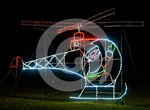 nighttime light show Santa Claus in helicopter ready to fly and deliver presents