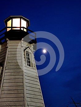 Nighttime lighthouse moon shot