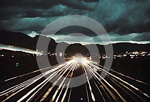 A nighttime scene capturing the lights of a busy highway.