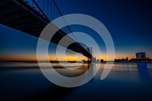 a bridge over a large body of water in the night