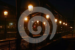 nighttime shot of station illuminated by streetlamps