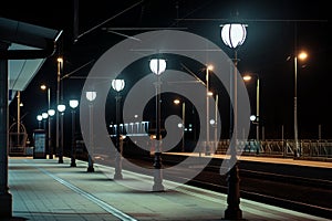 nighttime shot of station illuminated by streetlamps