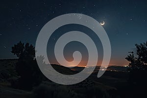 nighttime sky with moon and stars, during total eclipse