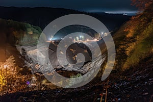 nighttime view of landslide with searchlights shining on the scene