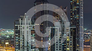 Nighttime view of lights from skyscrapers at evening in Dubai aerial timelapse