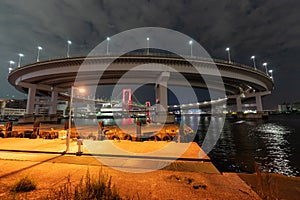 Nightview of Rainbow Bridge, illuminated in red as a sign of coronavirus alert