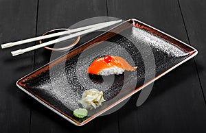 Nigiri with salmon on dark wooden background. Gunkan Sushi set. Japanese cuisine.