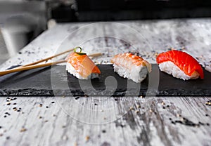 Nigiri sushi set, close-up. Fresh salmon, white fish, and shrimp on rice