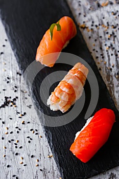 Nigiri sushi set, close-up. Fresh salmon, white fish, and shrimp on rice