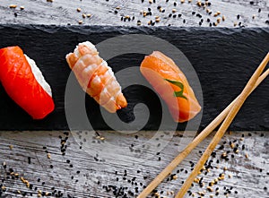 Nigiri sushi set, close-up. Fresh salmon, white fish, and shrimp on rice