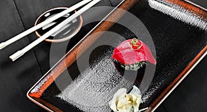 Nigiri with tuna on dark wooden background. Gunkan Sushi set. Japanese cuisine. Top view.