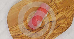 Nigiri tuna sushi rotating on wood