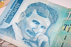 Nikola Tesla 100 dinar bill in the pile of Serbian dinars bills