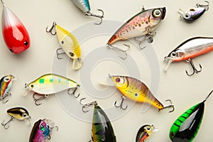 Nikolaev, Ukraine - 08 july, 2022: Colorful fishing lures, wobbler, spinner, on grey background, different fishing baits