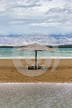 Nin, Croatia - Reed sunshade at the empty Queen\'s Beach by the mediterranean town of Nin at the end of summer