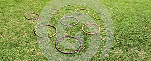 Nine 9 hula hoops on a green grass