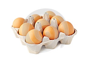Nine brown fresh eggs in retail tray on white photo