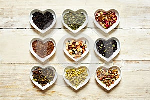 Nine colorful tea sorts in heart shaped bowls