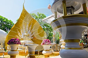 Nine headed great naga sculpture with golden Buddha statue at wat Rai-Khing Temple, Thailand.
