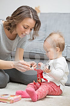 Nine months old baby girl playing with her mother