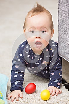 Nine months old baby girl playing with her toys