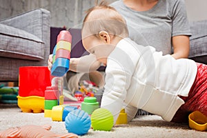 Nine months old baby girl playing with her toys