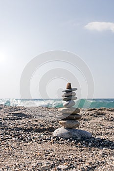 Nine pieces of stone in balance at the agitated seaside