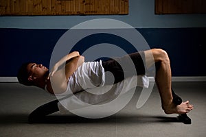 Nineteen year old teen boy doing situps in a tanktop