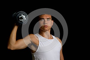 Nineteen year old teen boy exercising with a dumbbell